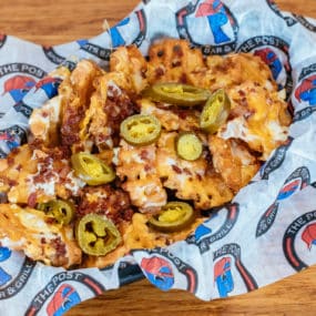 Loaded waffle fries with cheddar jack cheese, bacon, and jalapenos