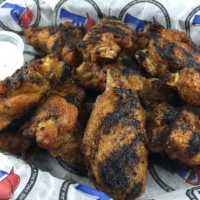 Memphis Wings Appetizer consisting of charbroiled and gently coated in a homemade Memphis-style rub and served with ranch