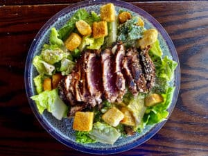 Blackened tuna with croutons lettuce and dressing